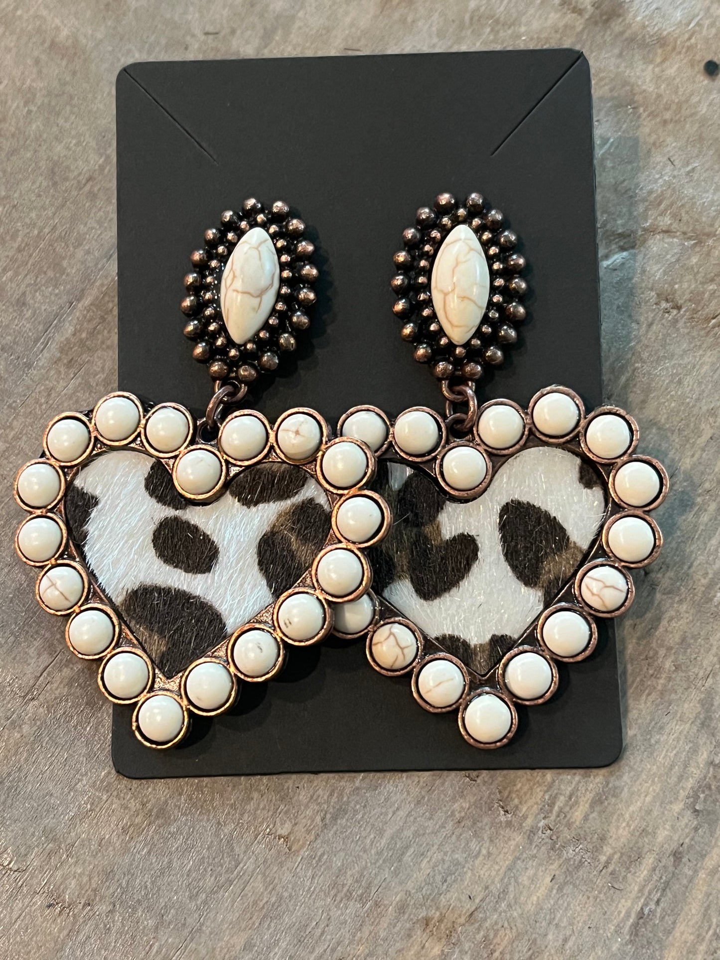 Heart shaped earrings with cream colored beading and leopard print