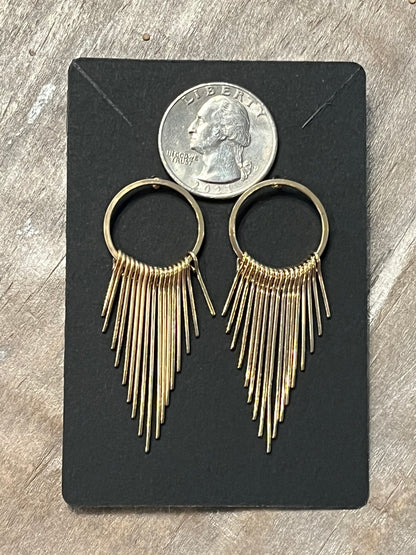 Gold earrings with dangling gold