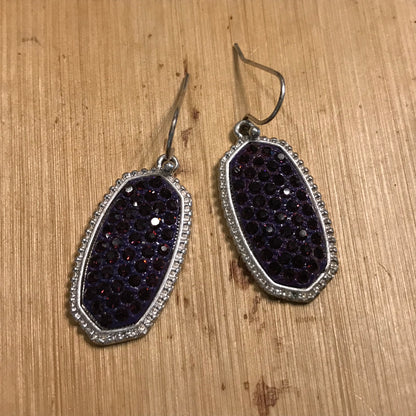 Silver earrings with purple stone inlay