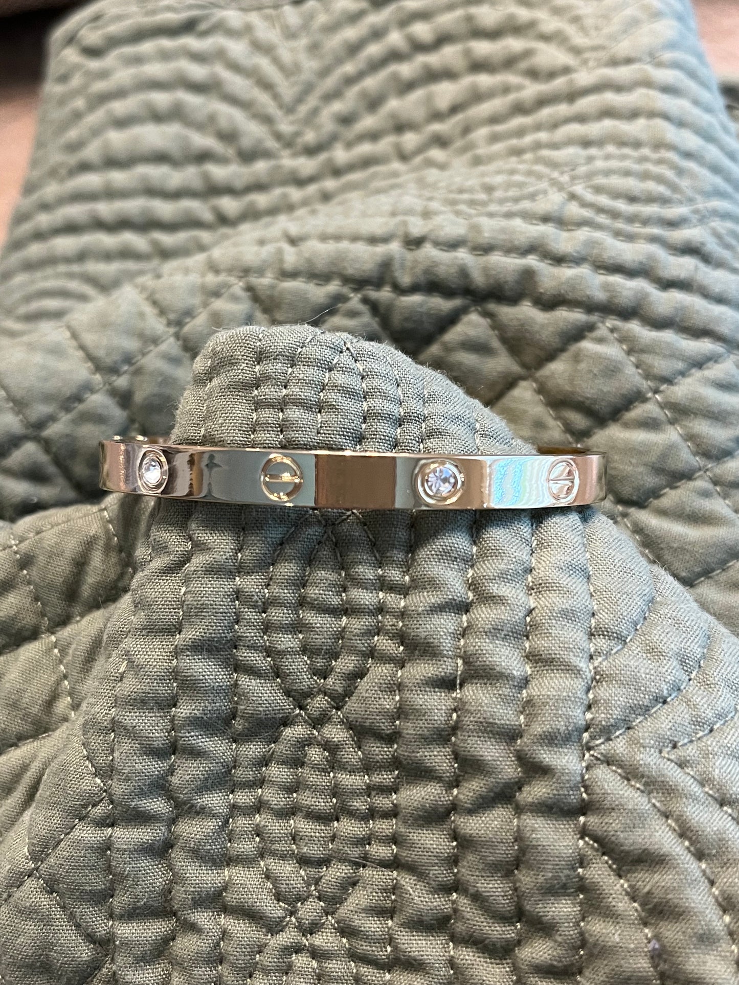 Love bracelet with alternating cz inlay and circle detail