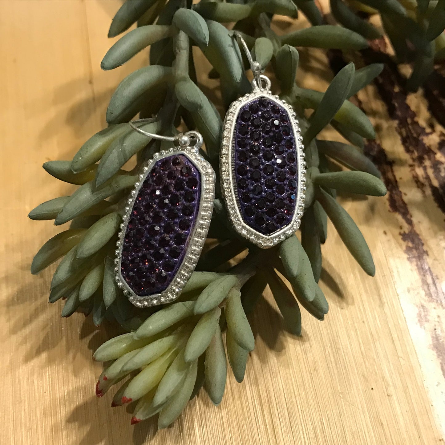 Silver earrings with purple stone inlay