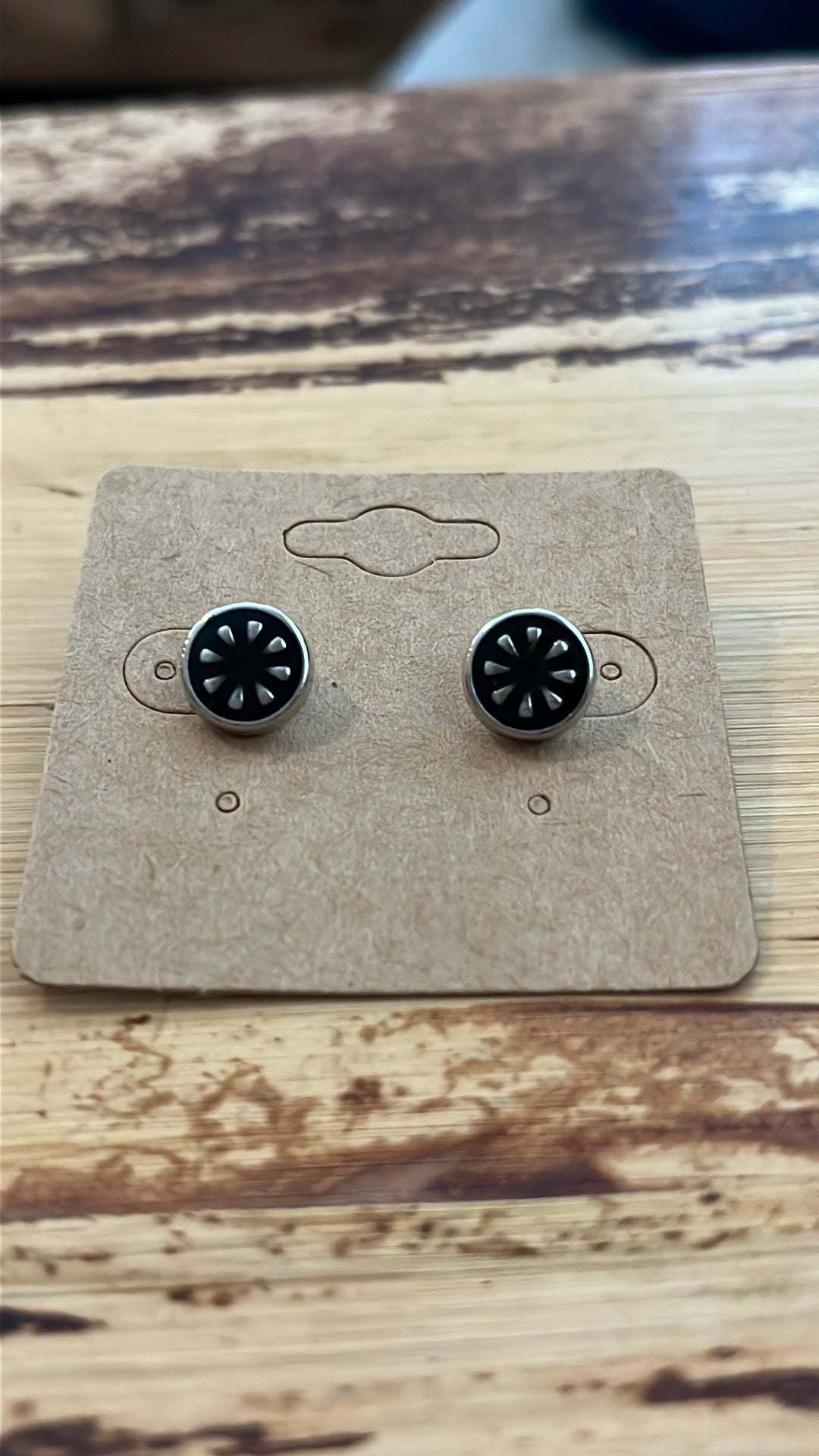 Black enamel stud earrings with silver-tone detail